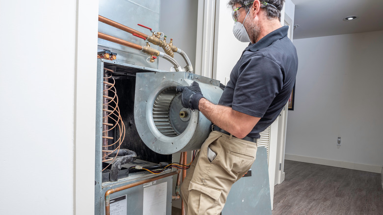 Man repairs motor in pump