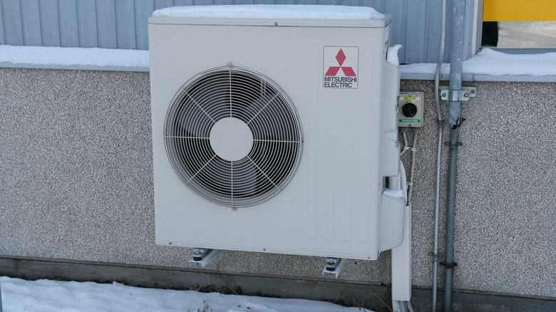 Heat pump in the snow in winter