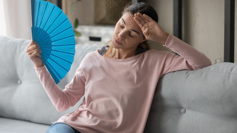 Woman fanning herself