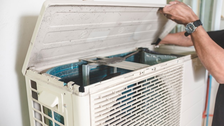 Man repairing heat pump