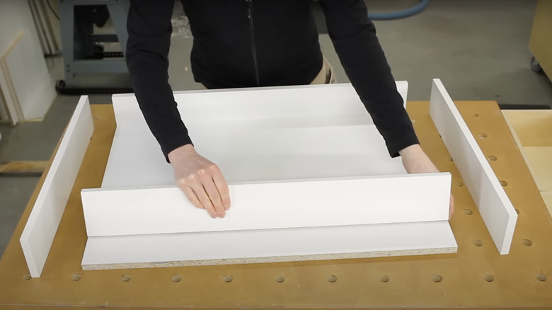 person assembling shelf