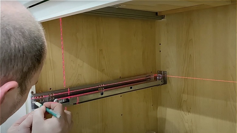 Person installing slider on cabinet