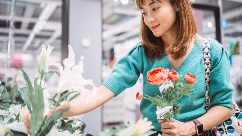 Woman buying artificial flowers in a store