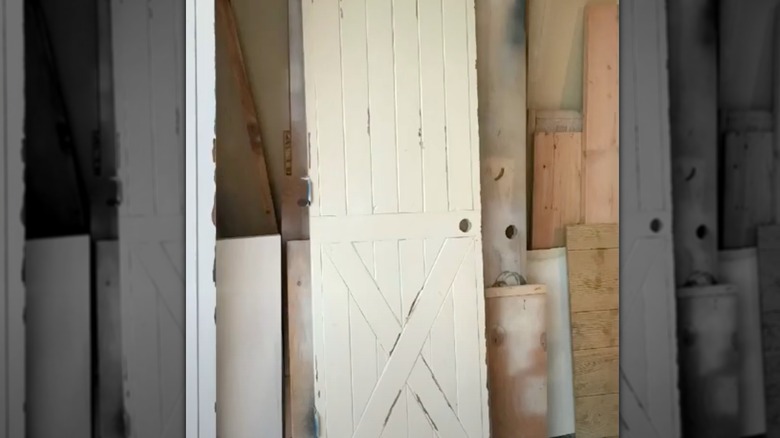 White farmhouse door with a distressed Old World style finish