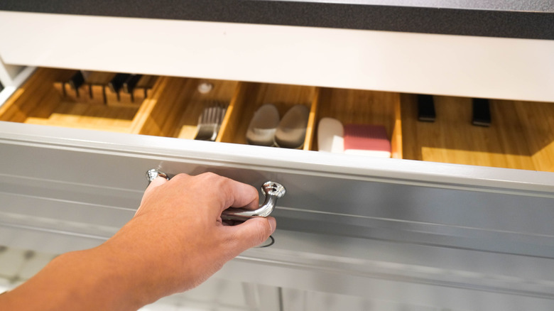 Person pulling out a drawer