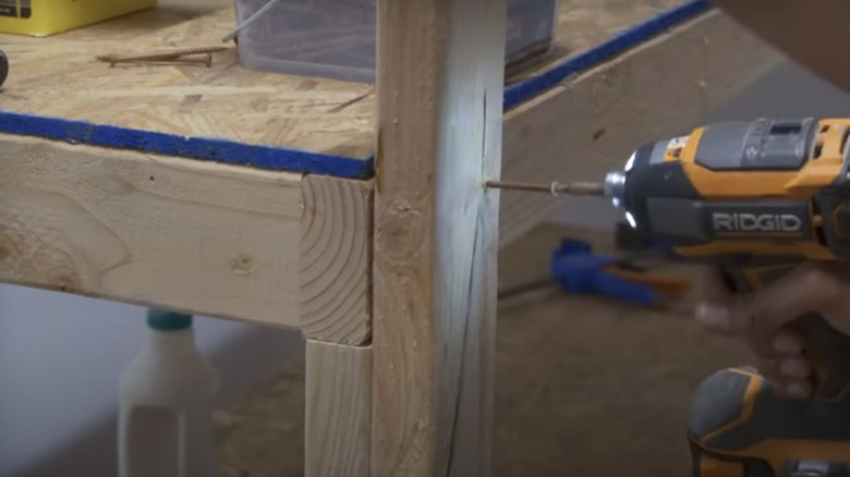 Screwing together heavy-duty garage storage shelves