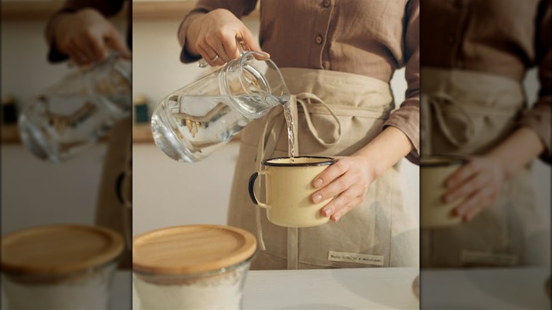woman pouring water into mug