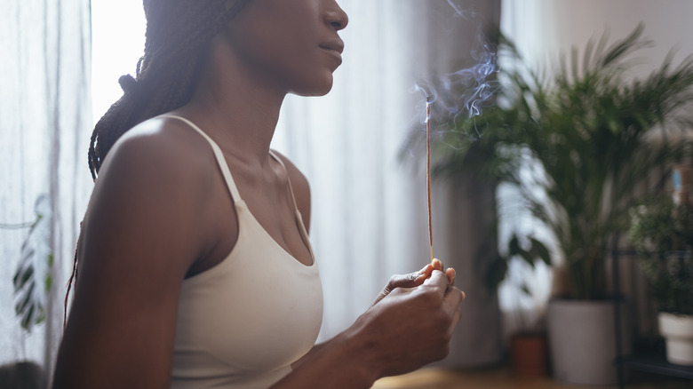 woman holding an incense stick