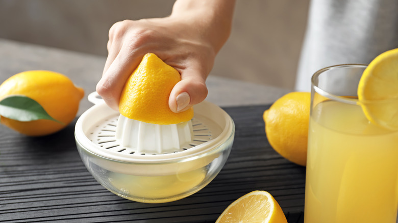 woman using lemon juicer