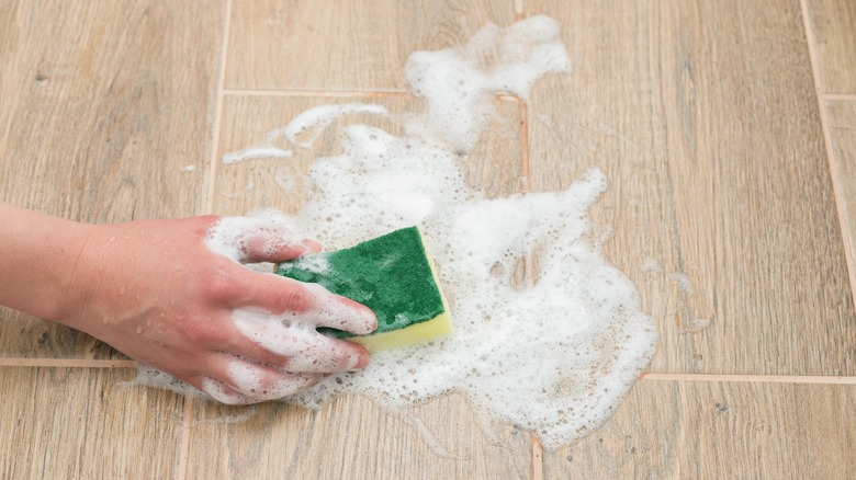 Mopping floor with soapy water