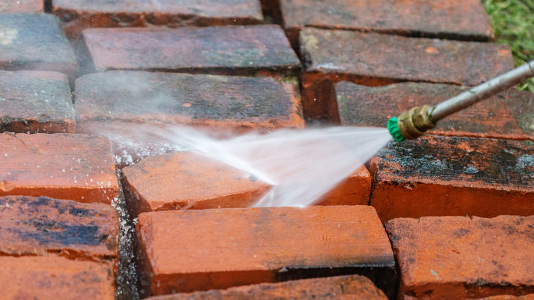 washing old bricks with hose