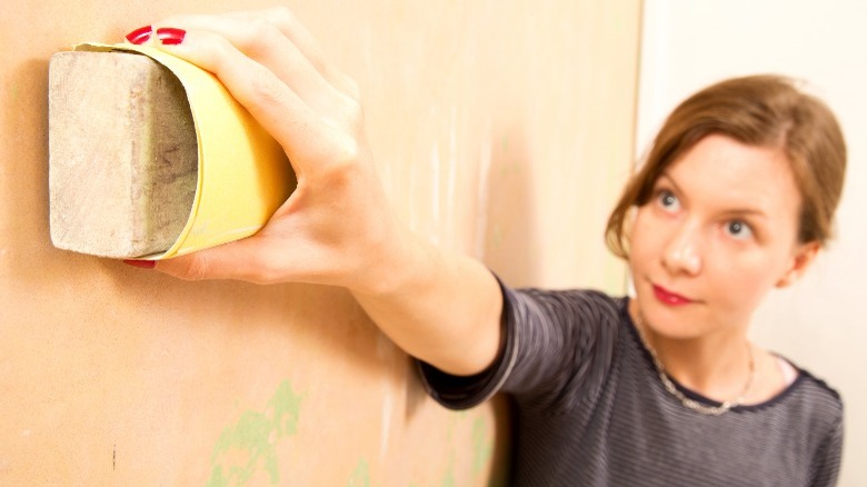 Woman holding dry cleaning sponge