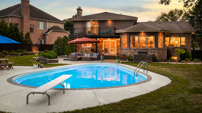 Pool behind suburban home