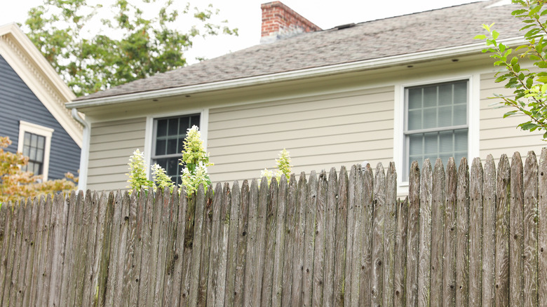 A home with a wooden fence around it.