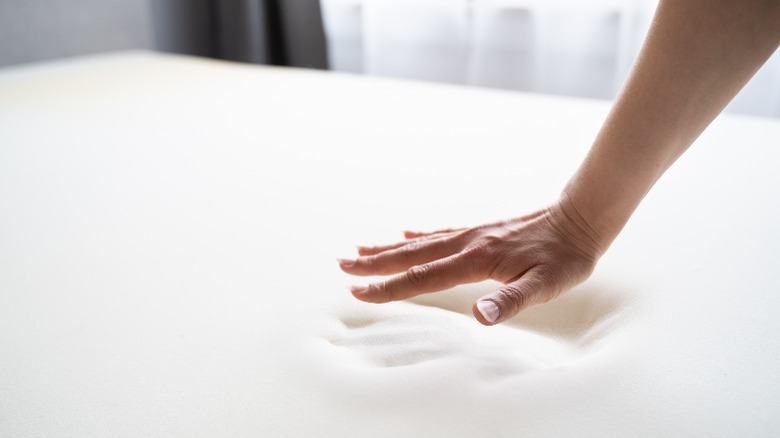 person pushing a memory foam