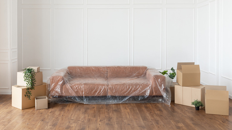 Plastic wrapped couch moving boxes