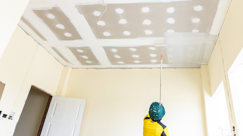 man painting ceiling