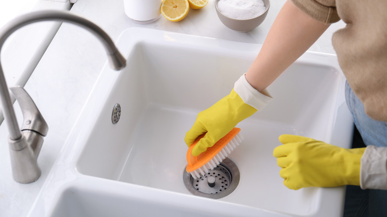 Person cleaning drain