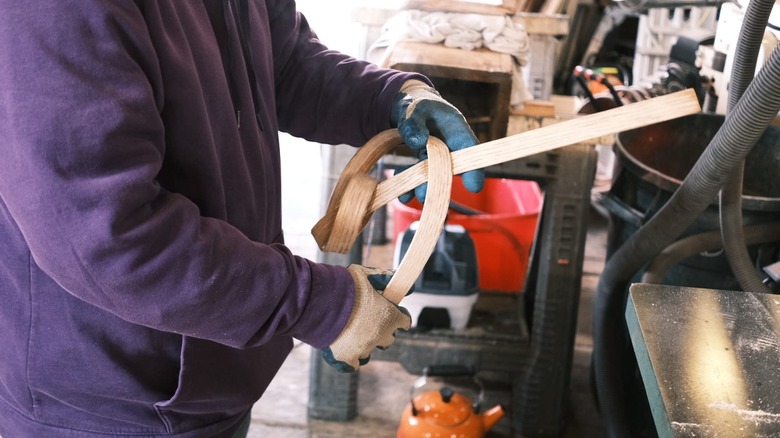 Person holding intricately bent wood