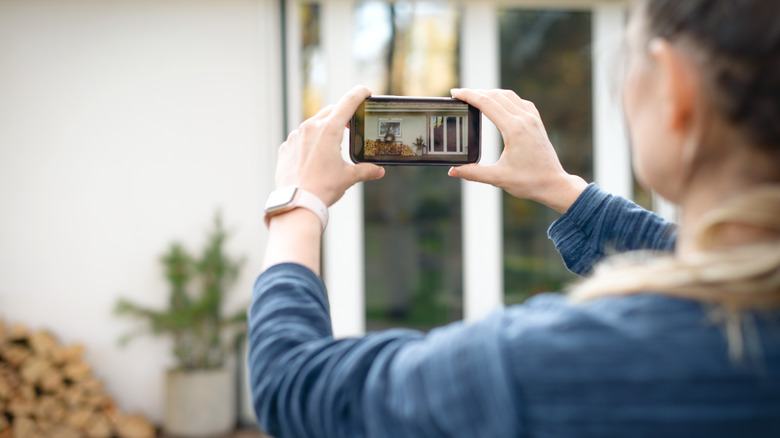 woman taking photo on phone