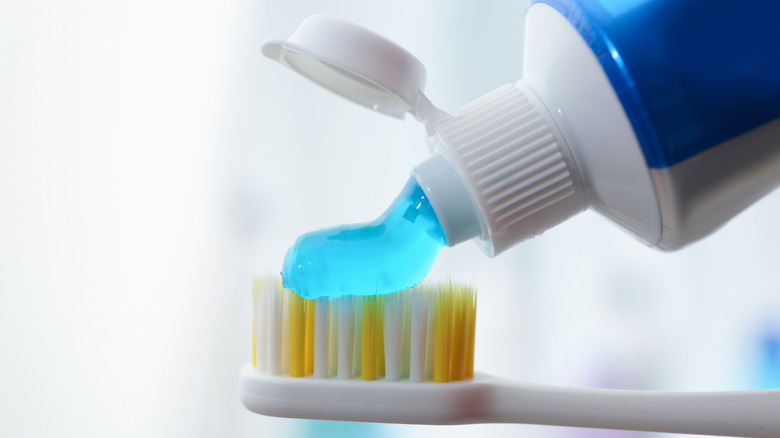 Blue toothpaste gel on toothbrush