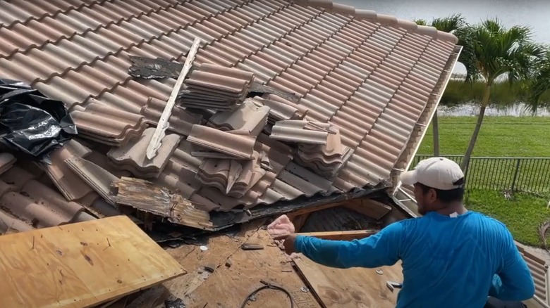 Man placing new plywood underlayment for a tile roof