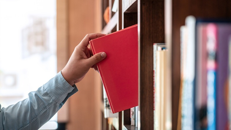 Taking a book off a shelf