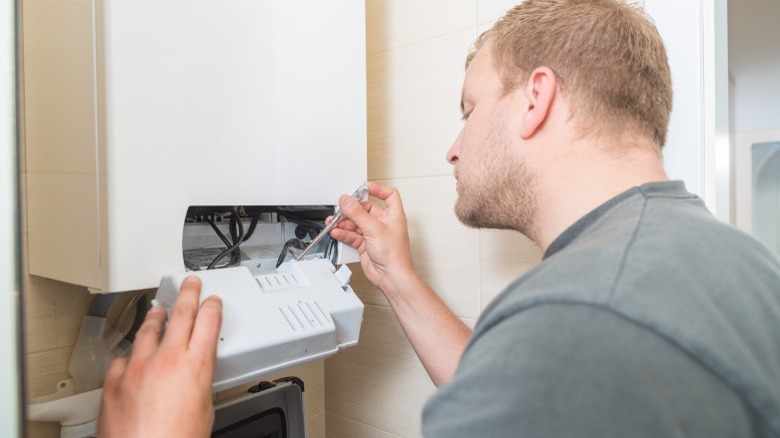 Man servicing home gas furnace 