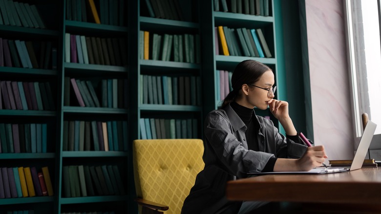 woman researching in turquoise library