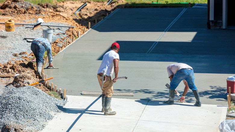 contractors working on concrete driveway