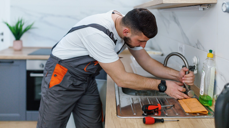 Man repairing a leaking faucet