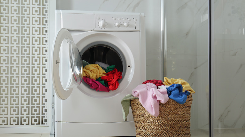 overflowing laundry at washing machine