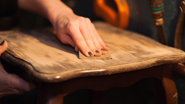 Person sanding down table