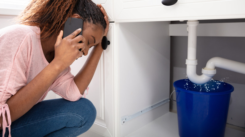 Frustrated woman calling plumber