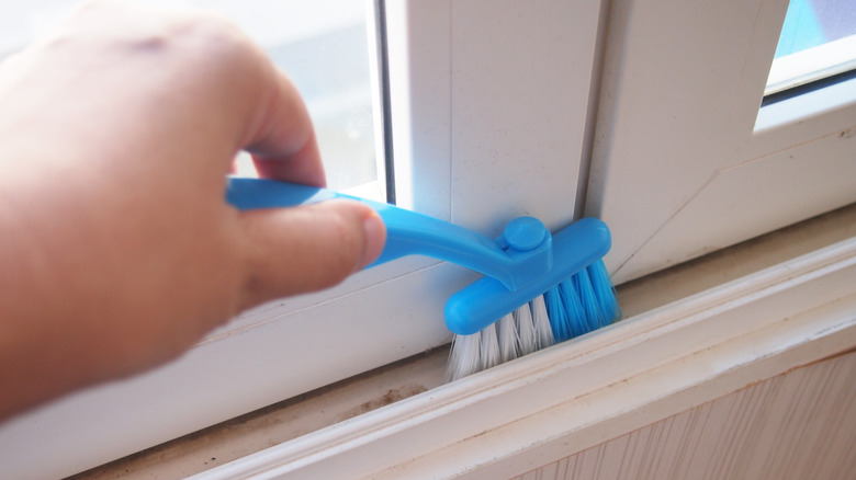 Brushing dirt from door tracks