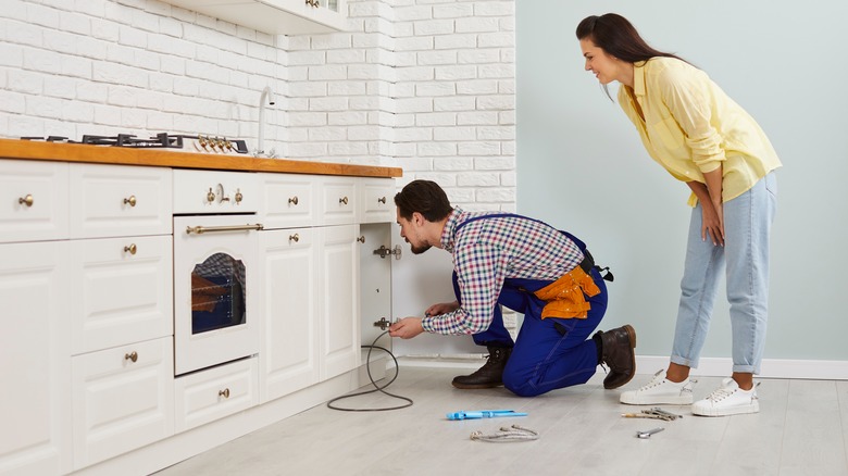 Inspecting kitchen sink pipe