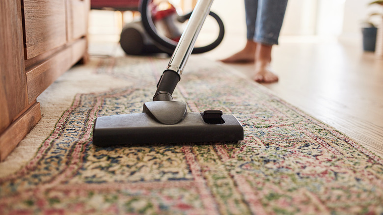 Vacuuming antique rug