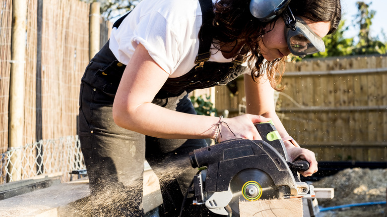 Woman using power tool