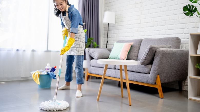 woman cleaning floor with mop