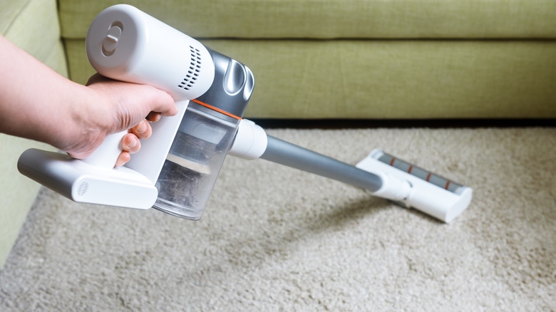 person vacuuming carpet