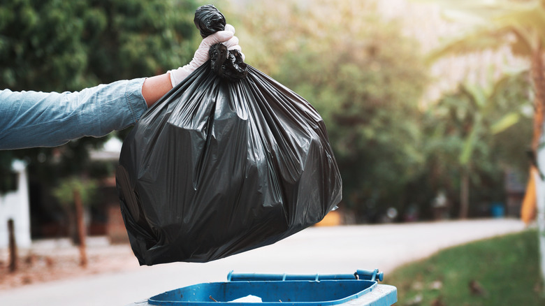 Person taking out garbage