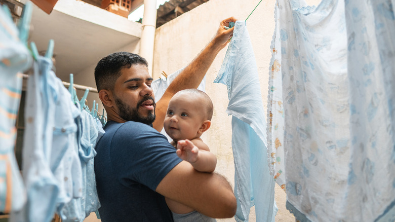 man hanging clothes