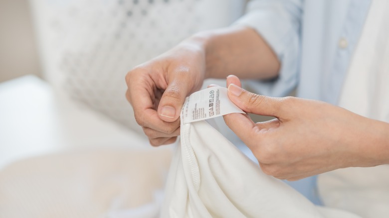 person checking label of fabric