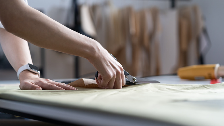 fabric being cut on table