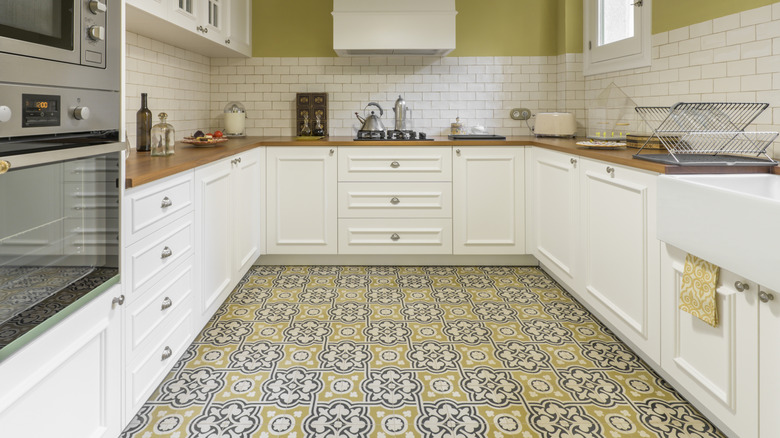 A kitchen with colorful, patterned floor tiles.