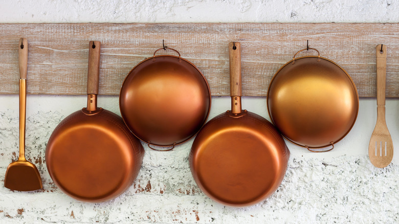 pans hanging on whitewashed brick