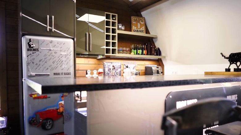 Bar with gray countertops and green cabinets in Mike Holmes' garage