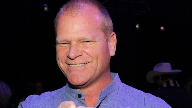 Mike Holmes smiling in blue shirt