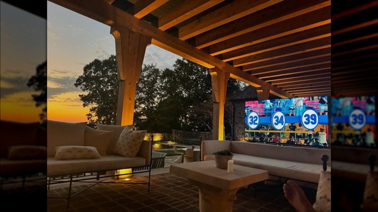 A candid photo of Tim McGraw's outdoor patio couches and big screen tv