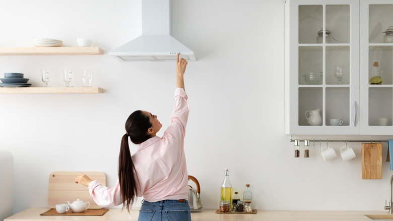 woman and kitchen exhaust fan